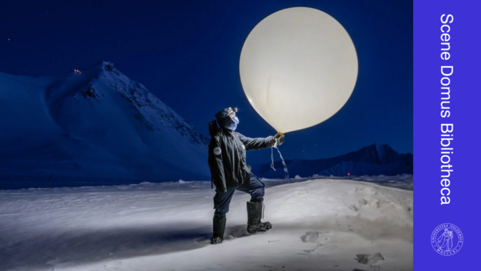 Photo of a arctic researcher with a large white balloon.