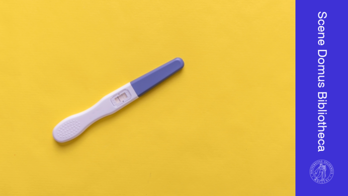 A positive pregnancy test on a yellow background