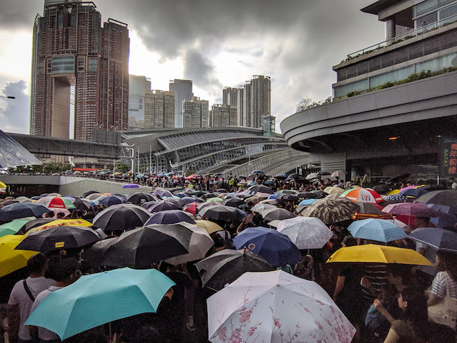 Image may contain: crowd, people, product, sky, city.