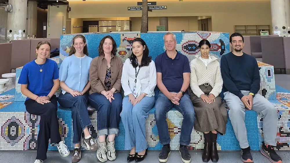 Director Carl Henrik Gørbitz seated with new the early-career researchers.