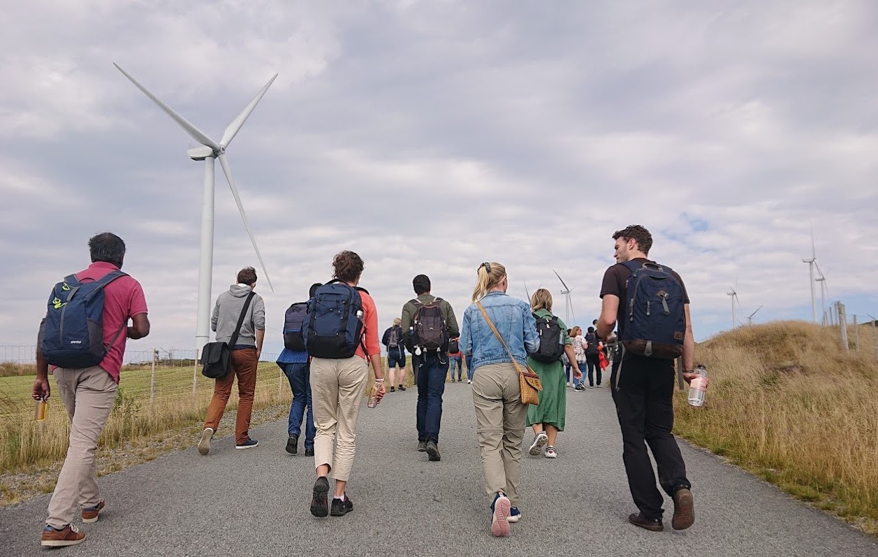 Image may contain: Wind farm, Wind, Wind turbine, Windmill, Recreation.