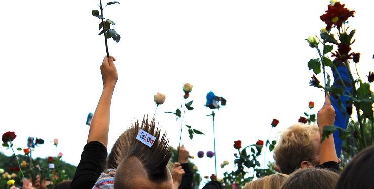 Rose March 2011, image with many hands holding different colored roses in the air