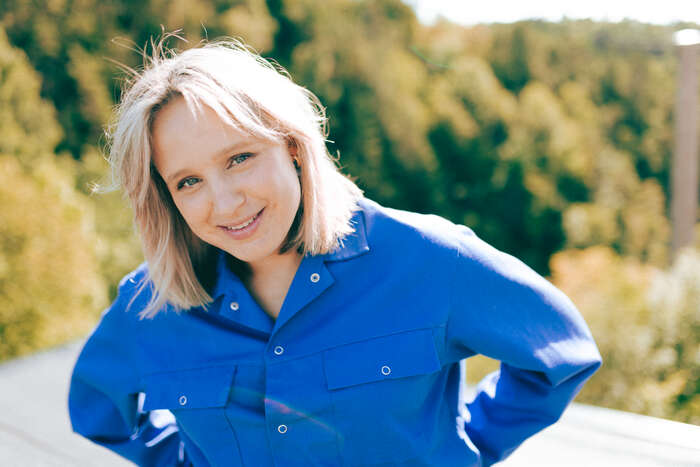 A young woman in a blue blouse