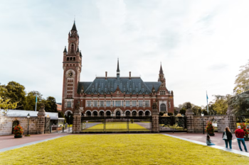 Bilde av Court of Justice. Et stort flott bygg med en stor grennplen foran.