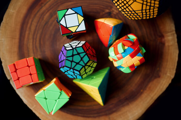 Many Rubiks cubes in different sizes, shapes and colors
