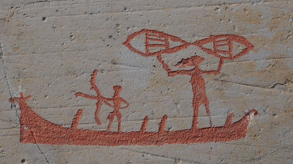 Red rock art on grey stone.