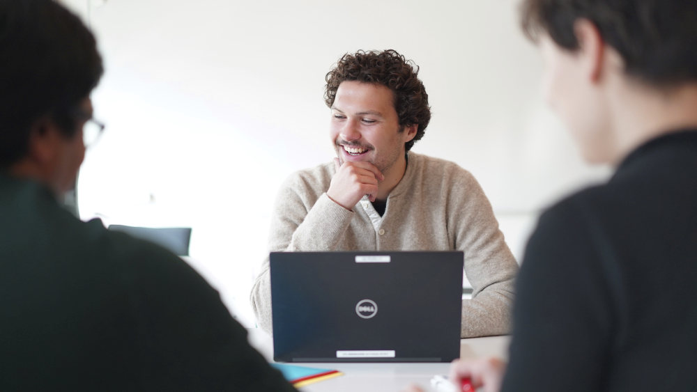feedback exchange between phd students in a meeting room. Photo: Shane Colvin