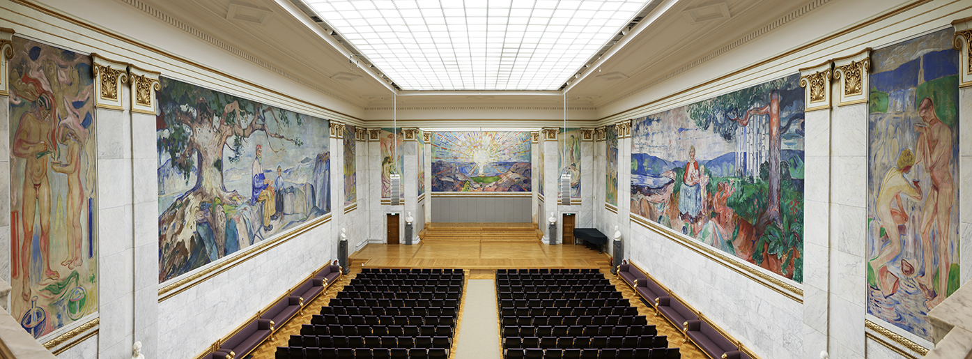 The university's assembly hall where the walls are covered with large canvas paintings. Photo.