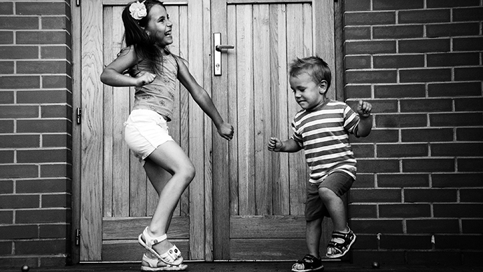  Black and white photo of two children dancing.