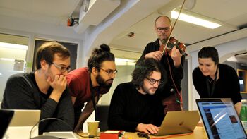 A group working on physical modelling of a bowed instrument using motion capture data as input.