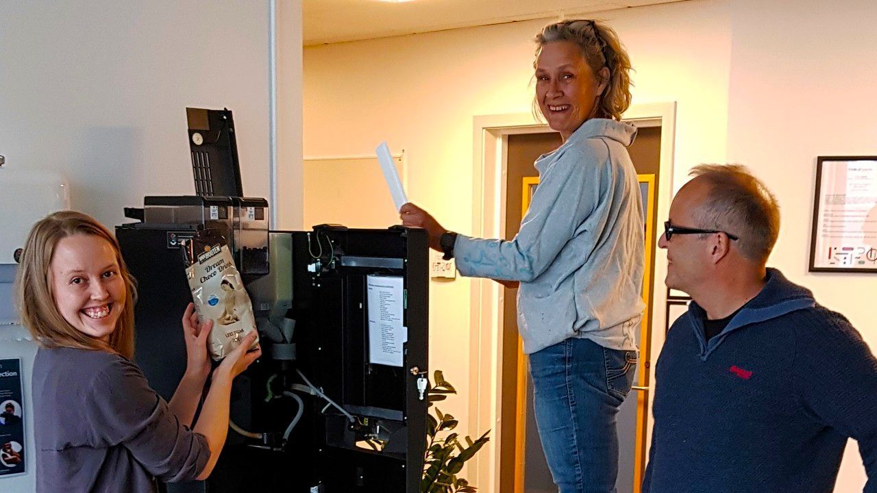 PhD fellow Maja Dyhre Foldal assists Centre Director Anne Danielsen in refilling the coffee machine. Professor Erling Guldbrandsen follows at a respectful 1 meter distance.