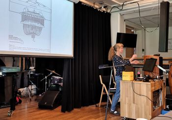 Public address system ,Computer ,Audio equipment ,Curtain ,Guitar.