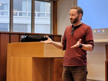 Electronic device ,Standing ,Laptop ,Furniture ,Podium.