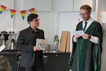 Image may contain: Glasses, Eyewear, Vision Care, White-collar worker, Academic dress.