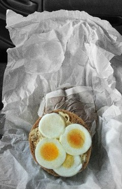 Sandwich with egg in food paper.