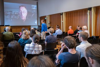 Chair ,Event ,T-shirt ,Crowd ,Public speaking.