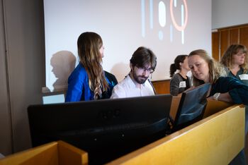 Computer ,T-shirt ,Jacket ,Event ,Electronic device.