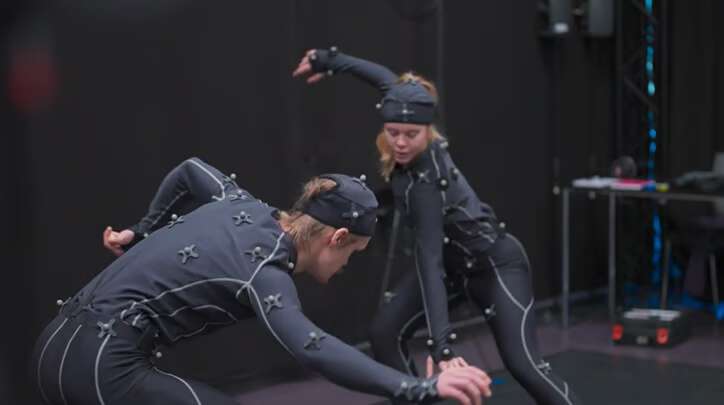 Two dancers are improvising in the same studio space