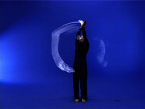 Dancer in black with blue surroundings.