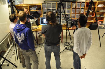 Jeans ,Standing ,Computer ,Chair ,T-shirt.