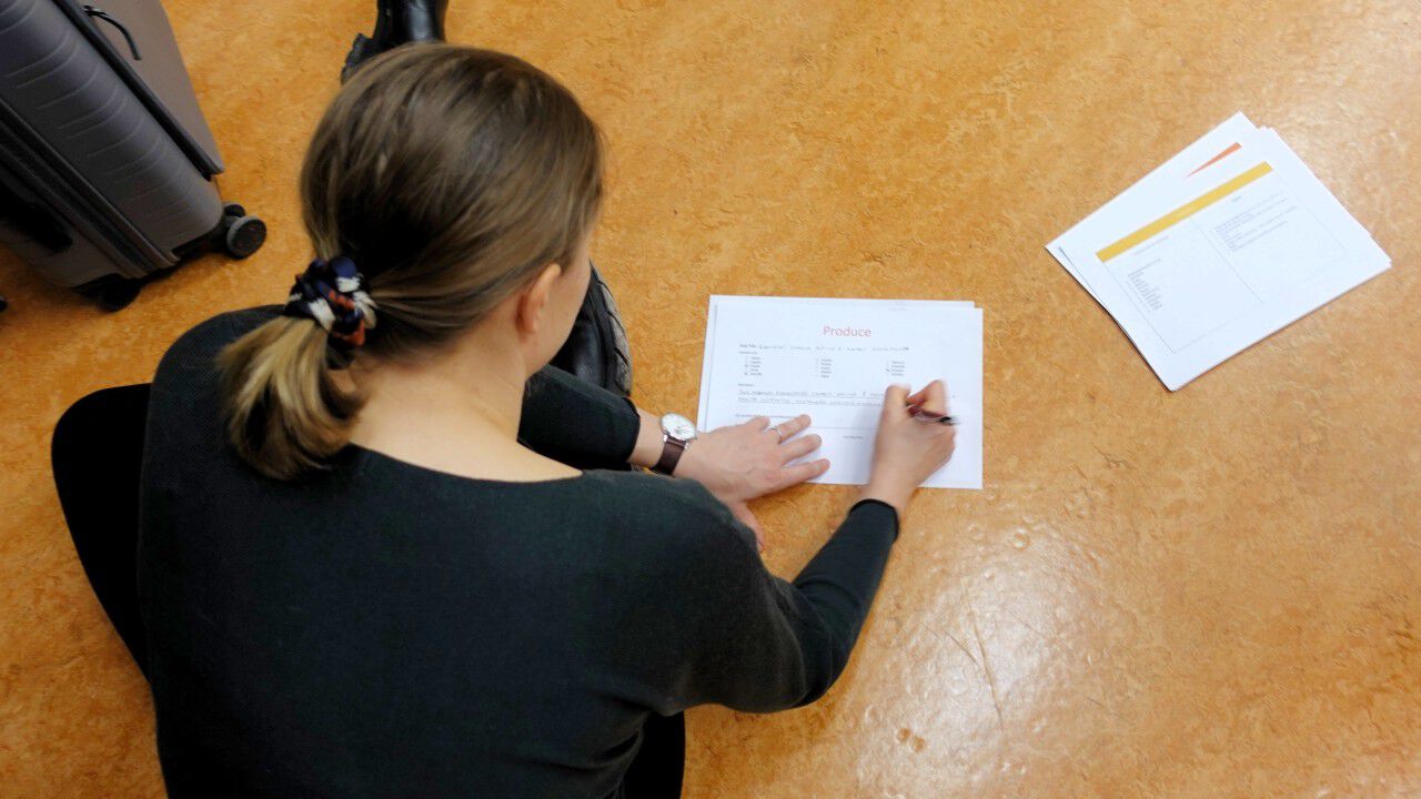 Person writing on paper
