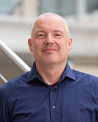 Photo of Gard Thomassen, a man of about 50 wearing a blue shirt. He looks cheerfu